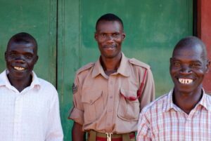 John Chikayiku Nthara Banda [left] and Jamu Kalipentala Banda [right], with Malawi Prison Service Officer Andrew Dzinyemba. John and Jamu were released after 20 years. The judge considered witness statements collected by the state and the defence which showed that the men had been trying to assist the victim