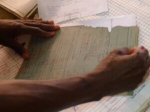 Zomba, February 2015 –a prison officer marks the prison record of a man released after a sentence rehearing where the court considered evidence gathered by paralegals